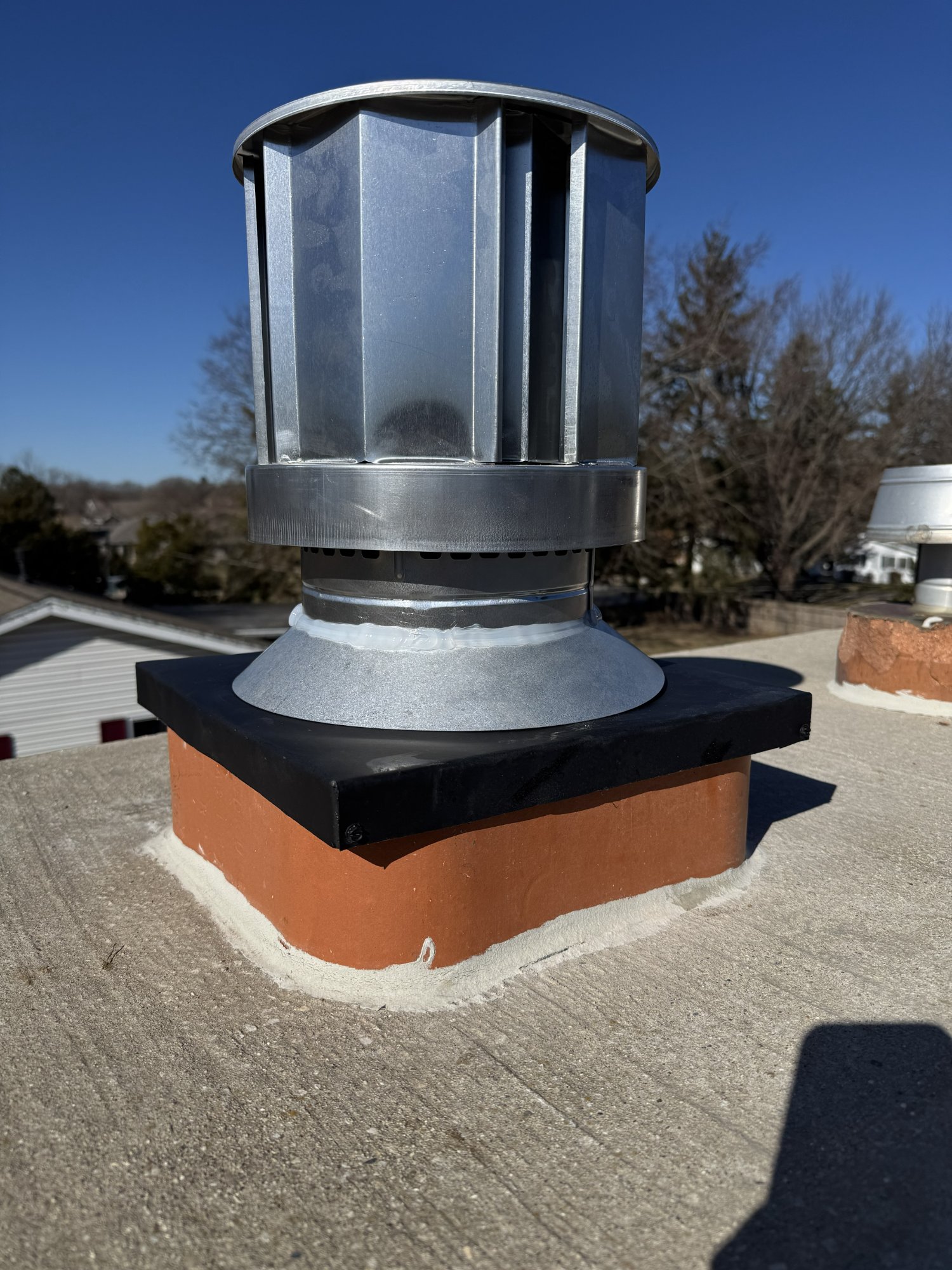 Decorative round chimney cap on masonry chimney — Dane County WI