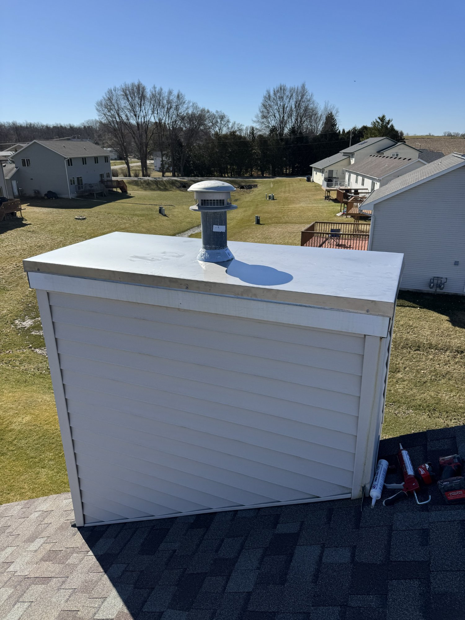 Wide custom chase cover with flue cap — residential Madison WI